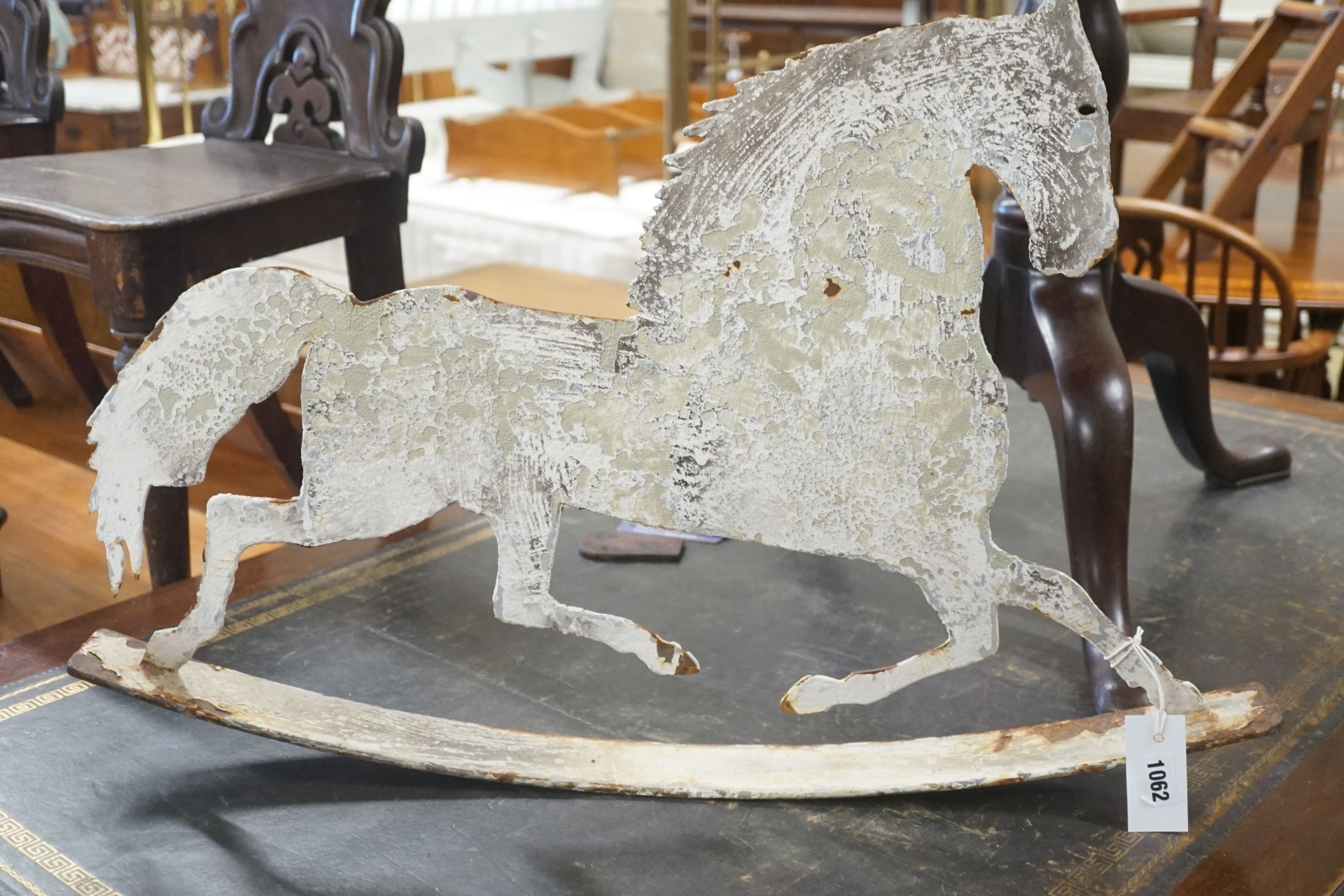 A painted iron rocking horse ornament, length 75cm